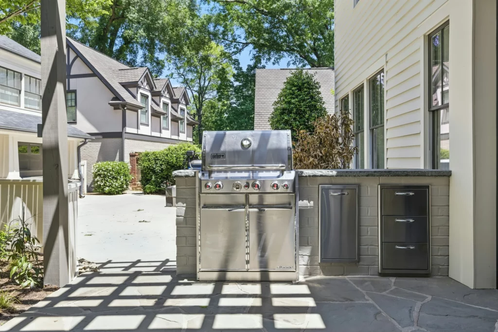 Built-in outdoor grill island with a stone top