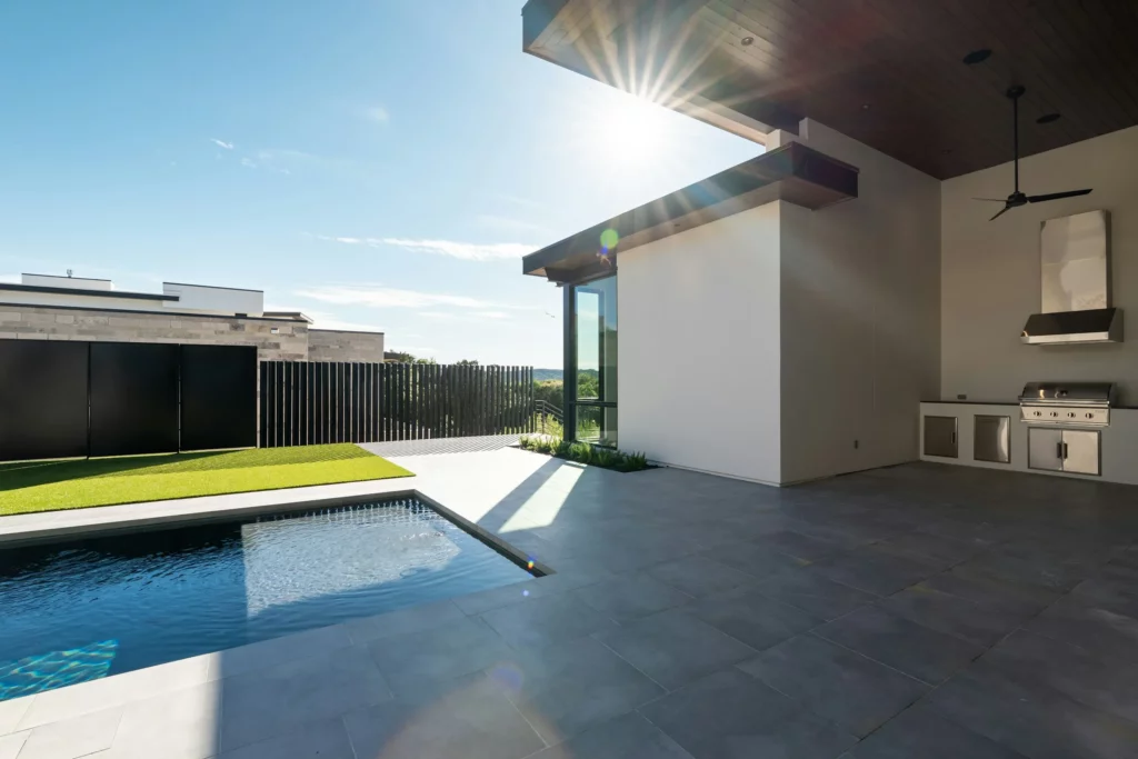 Covered outdoor kitchen beside a pool